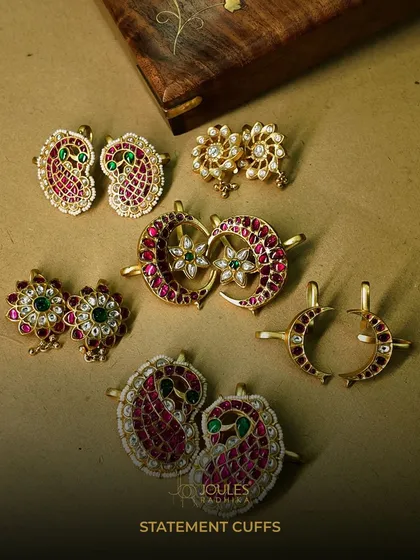 A beautiful flat-lay of our statement cuffs. This collection showcases a variety of designs, from paisley motifs to crescent moons, all crafted with colorful stones and polki.
