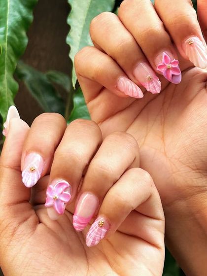 A full view of both hands, showing the complete 3D floral and plaid summer set.