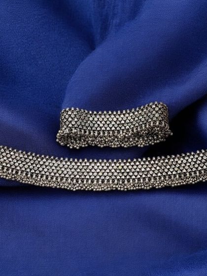 A pair of our beautiful mesh-style silver anklets. These flexible payals are adorned with tiny ghungroo bells that jingle with every step.