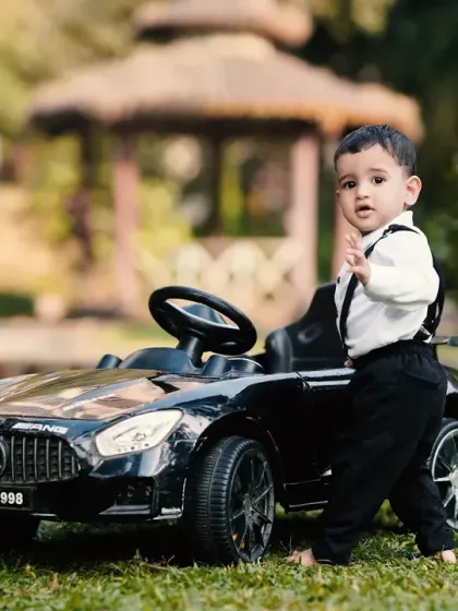 A stylish pose next to the mini car. I guide children into natural poses that showcase their personality during these fun outdoor photoshoots.