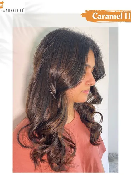 The profile view of the soft caramel hues, showing how the color enhances the client's features and adds warmth to her look.