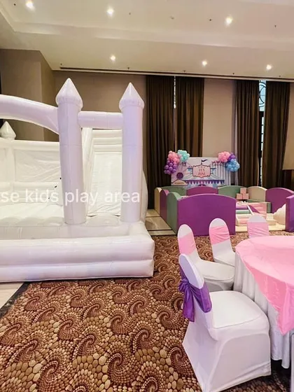 The party is ready to begin, with our white bounce castle waiting for its first guests next to a beautifully decorated kids' table.