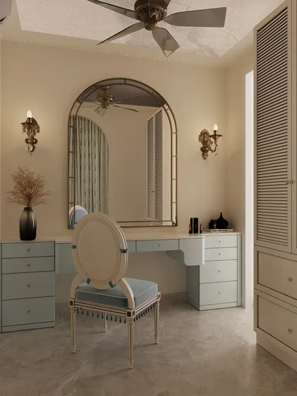 The vanity area is fit for royalty, with a large arched mirror, classical sconces, and a beautiful powder blue desk with an ornate chair.