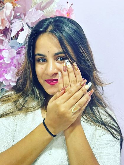 A happy client showing off her amazing nail transformation. Swipe to see the before.