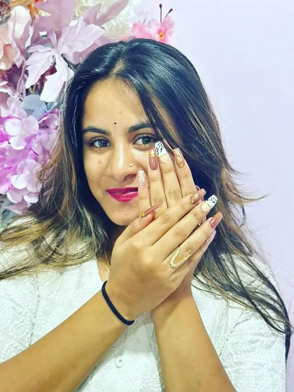 A happy client showing off her amazing nail transformation. Swipe to see the before.