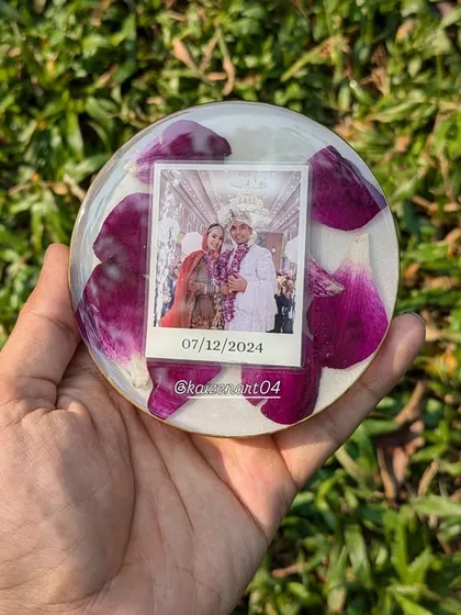A 4-inch circular keepsake with purple petals and a polaroid-style photo. It's a small, sweet, and affordable way to preserve a cherished memory.