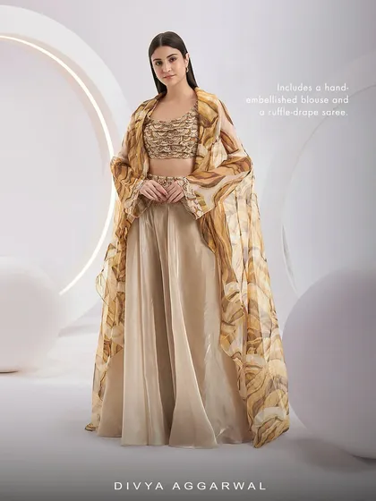 This view of the Adoree Cape Set showcases the hand-embellished blouse and the flowing, printed ruffle-drape saree.