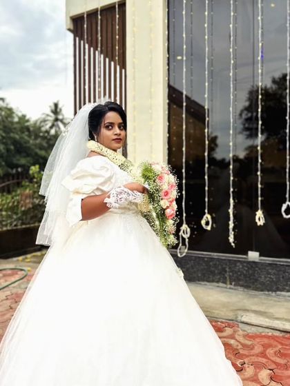 The beautiful bride Rachel glowing in her custom Turkish-style ball gown. The puffed sleeves and intricate handwork were designed to highlight her natural beauty.