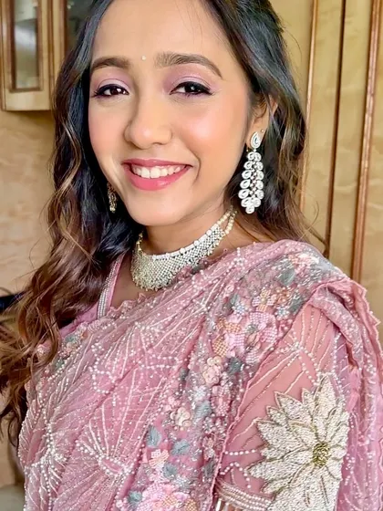 A close-up of the pretty in pink look, with shimmering eyeshadow and a radiant smile.