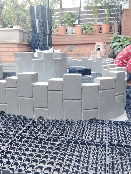 Here we are constructing a custom-shaped planter base on top of the drain cell layer. This method allows us to build unique garden designs directly onto a terrace.
