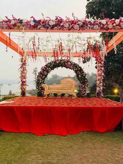 A daytime view of the same outdoor mandap, showing the natural beauty of the flowers and the structure before the lights take over.