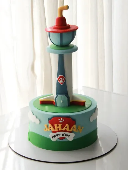 A Paw Patrol cake featuring the iconic lookout tower. The entire structure is part of the cake design, making it a fun and recognizable centerpiece for a fan's birthday.