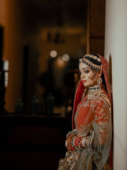 A contemplative portrait of the bride. The soft, directional lighting highlights her features and creates a quiet, emotional mood.
