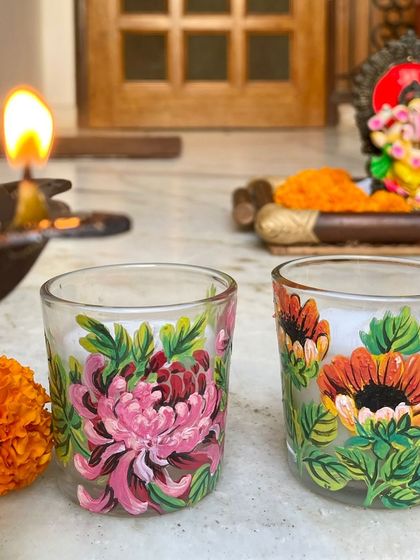 A set of candles painted with beautiful, detailed chrysanthemums.