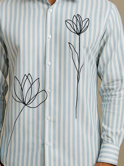 This close-up focuses on the lower part of the shirt, showing the placement of the second flower and the quality of the striped fabric.