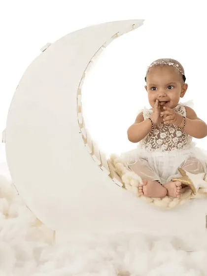 A sweet and shy smile from the moon prop. I capture a range of expressions to give you a full story of your baby's session.