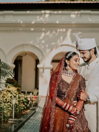 A serene portrait of the couple, framed by the elegance of a sunlit courtyard. We find those perfect, quiet spots to capture your connection, creating wedding day portraits that are both classic and deeply personal.