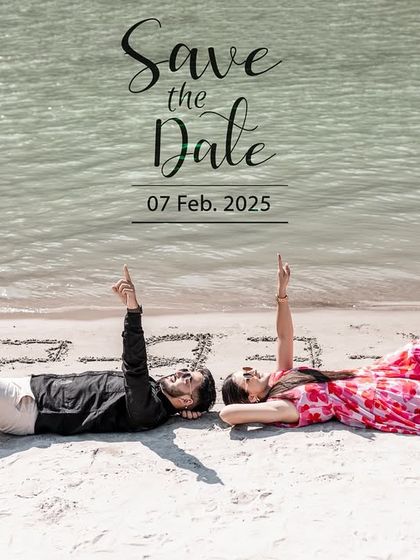 A creative "Save the Date" shot with the couple lying on the sand, pointing up to the text. This is a fun and personal way to announce your wedding date.