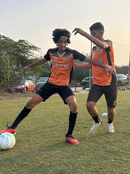 An intense moment during a training match, as one player tries to dispossess another.