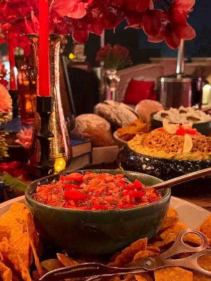 A vibrant display of fresh salsa and tortilla chips, part of a themed culinary journey. We use high-quality ingredients to create authentic and crowd-pleasing flavors for any celebration.