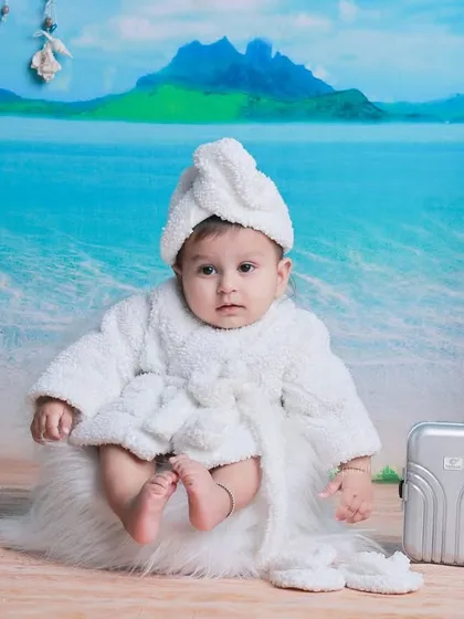 Ready for a day at the spa, beach edition. This baby in a fluffy white robe and towel turban is the picture of relaxation against our beach backdrop.
