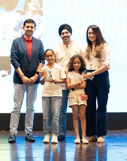 This family celebrates their daughter's achievement in the Bravo Xcelerate program.