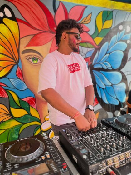 Another look at me on the decks during the colorful outdoor event. I'm always watching the crowd, adjusting the mix to make sure the energy never drops.