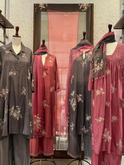 A full display of Kora's luxurious collection, showcasing different silhouettes in muted, sophisticated tones with beautiful floral embroidery.
