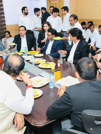 A candid photo from the farewell lunch, capturing the spirit of camaraderie between members of the bar and the bench.