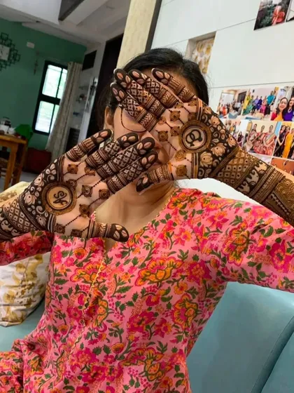 A client hiding her face playfully behind her hands, which feature 'OK' initials for her engagement.