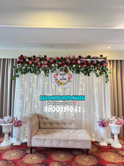 We love creating classic and elegant engagement stages. This setup features a beautiful floral header, a fairy light curtain, and a comfortable sofa for the happy couple.