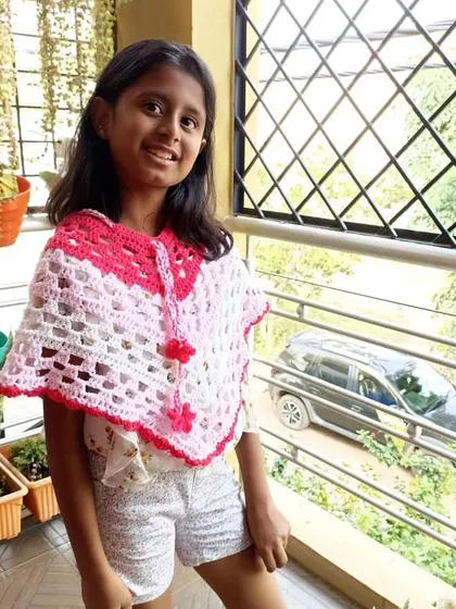 This beautiful crochet poncho is perfect for kids. It's a great layering piece, and this customer looks adorable in hers.