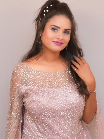 A close-up portrait in the lilac gown, showing the pearl details and the soft, romantic hairstyle.