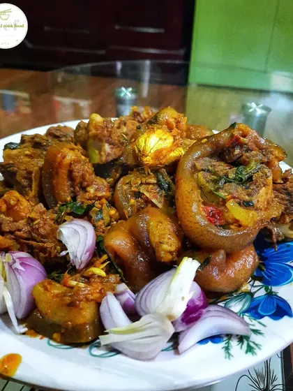 A plate of delicious pork, garnished with fresh onions.