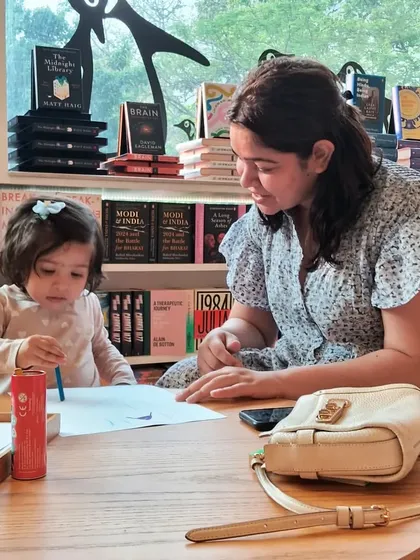 A sweet moment between a mother and her toddler at the art corner. It's never too early to start creating.