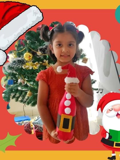 A young participant proudly holds the Santa themed bottle art she created during our Christmas party. It's a wonderful, handmade decoration to take home for the holidays.