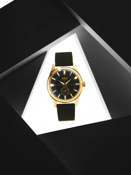 Framing is a powerful tool. Here, I used geometric black shapes to create a window, drawing the eye directly to the gold Argos watch. The contrast between the dark frame and the brightly lit center makes the product the undeniable hero.