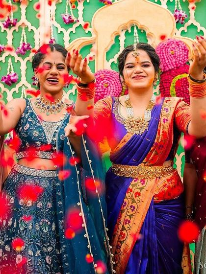 The bride and her bridesmaids shower the air with rose petals in a moment of collective joy and celebration.
