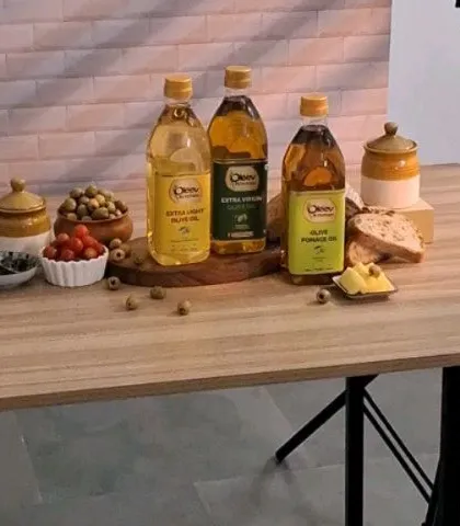 A wide shot of our Mediterranean-inspired kitchen setup for an olive oil brand, showing all the props and lighting equipment.