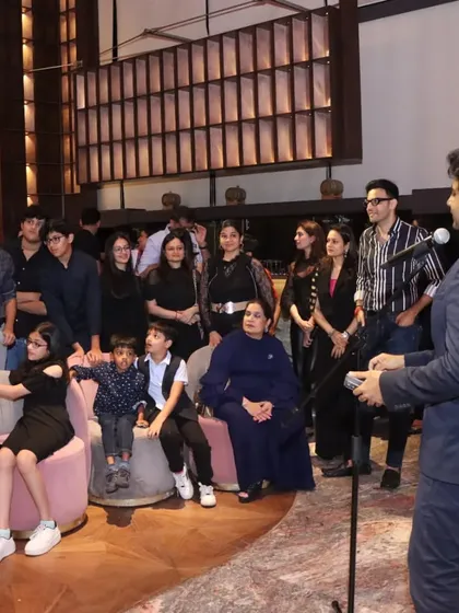 Addressing a group at a family celebration. My shows are designed to be enjoyed by all ages, from the youngest kids to the grandparents.