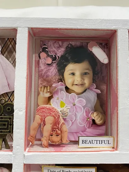 Another beautiful photo from the baby's first year, labeled 'Beautiful' and adorned with a butterfly and safety pin charm.