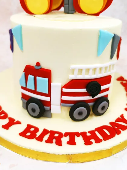 A close-up of the detailed firetruck and the bold "Happy Birthday" message in red.