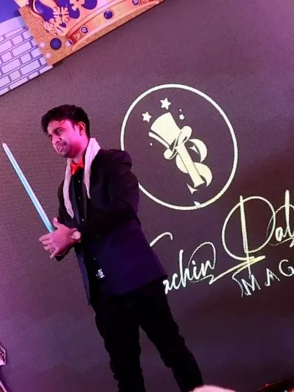 A shot from my show in Vrindavan, holding a magically appearing cane against my branded backdrop.