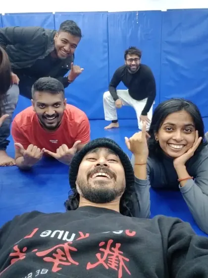 Having some fun on the mats after drilling techniques. Laughter and hard work are both part of the process.