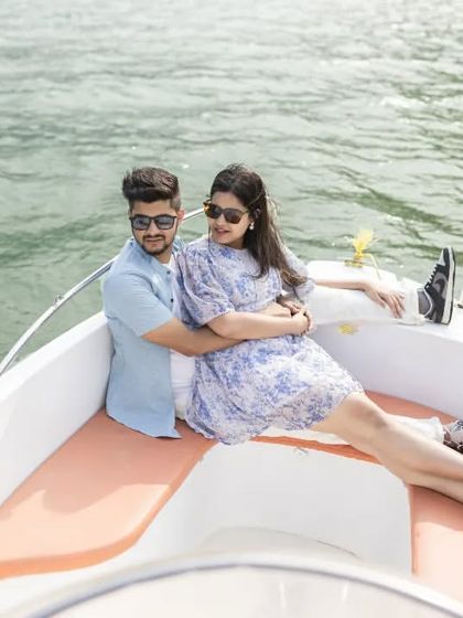 An intimate embrace while relaxing on the boat. This shot captures a quiet moment of connection amidst the beautiful scenery of Tehri.