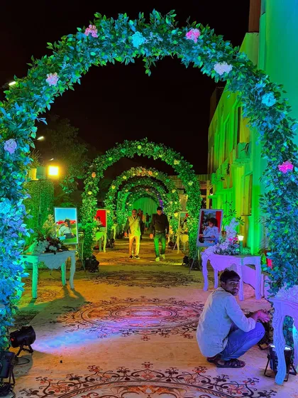 For a Mundan ceremony, I designed this enchanted garden entrance. A series of green arches with flowers leads guests down a path lined with photos of the child, making it a personal and heartwarming experience.