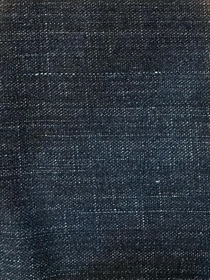 A dark, faded denim with a crosshatch texture. This fabric has a rugged, workwear feel, ideal for durable custom jeans or jackets.