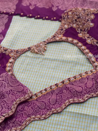 A purple blouse with brocade paisley motifs on the sleeves and back.