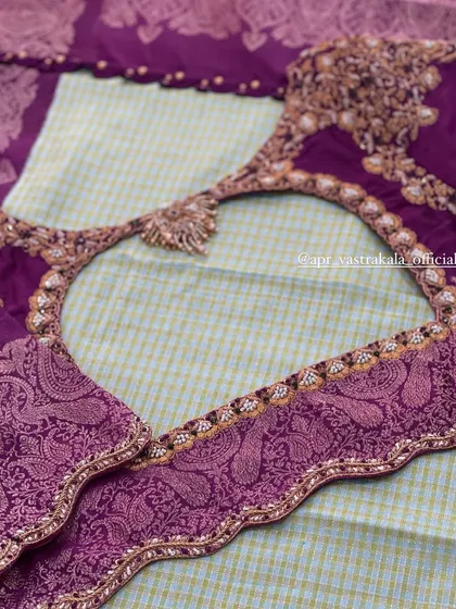 A heart-shaped back design on a purple blouse, showcasing a different style of embroidery with paisley motifs along the border.