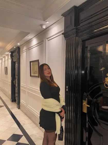 A side view of the elegant New Year's outfit in a classic hotel corridor.
